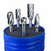 Five metallic rotary burr bits arranged in a blue plastic holder filled with dark grinding media, photographed on a white background.
