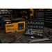 A socket set in a black case on a wooden bench in an engineering workshop